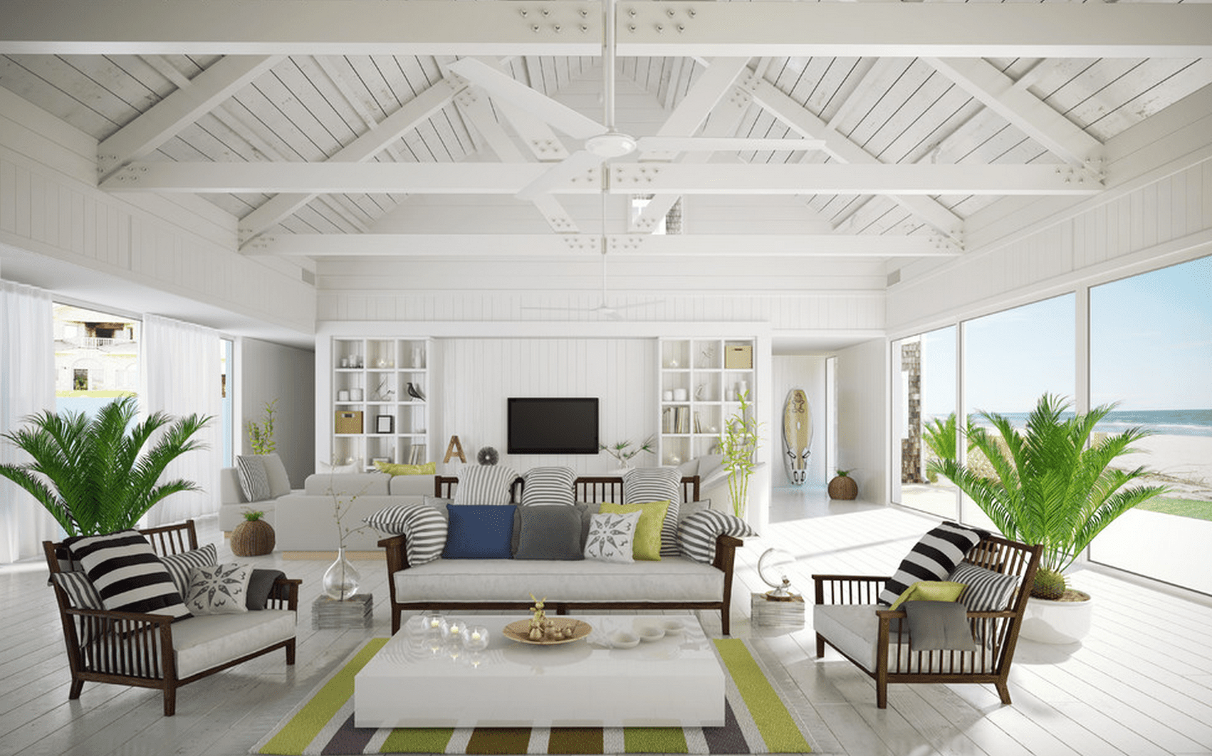 Bright coastal living room with large windows and modern furniture, representing vacation home monitoring with MarCELL.
